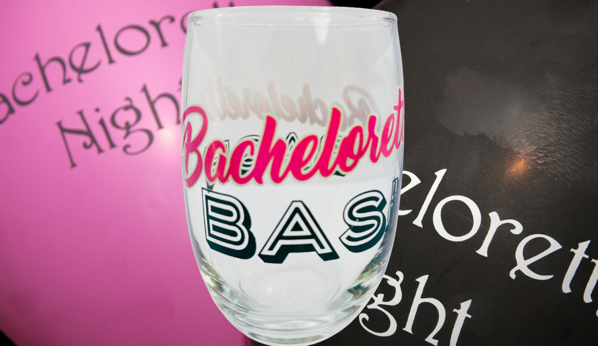 Bachelorette Bash Stemless Wine Glass displayed with bachelorette party decorations