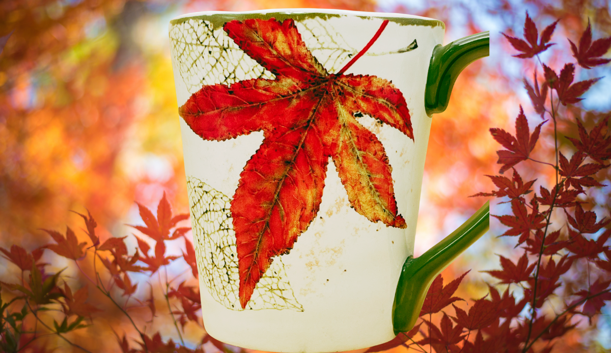 Pier 1 Asheville Fall Leaves Coffee Mug displayed against glowing red and orange autumn foliage