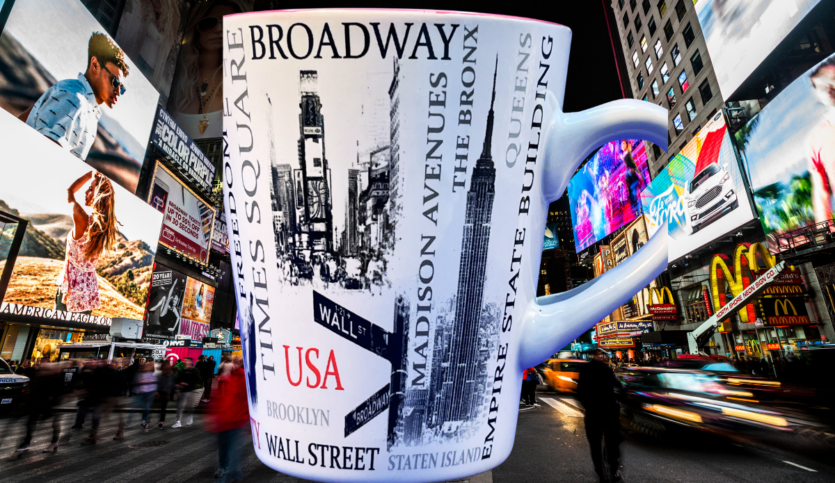 New York City Landmarks Mug displayed amid the bright billboards, traffic, and nighttime energy of Times Square