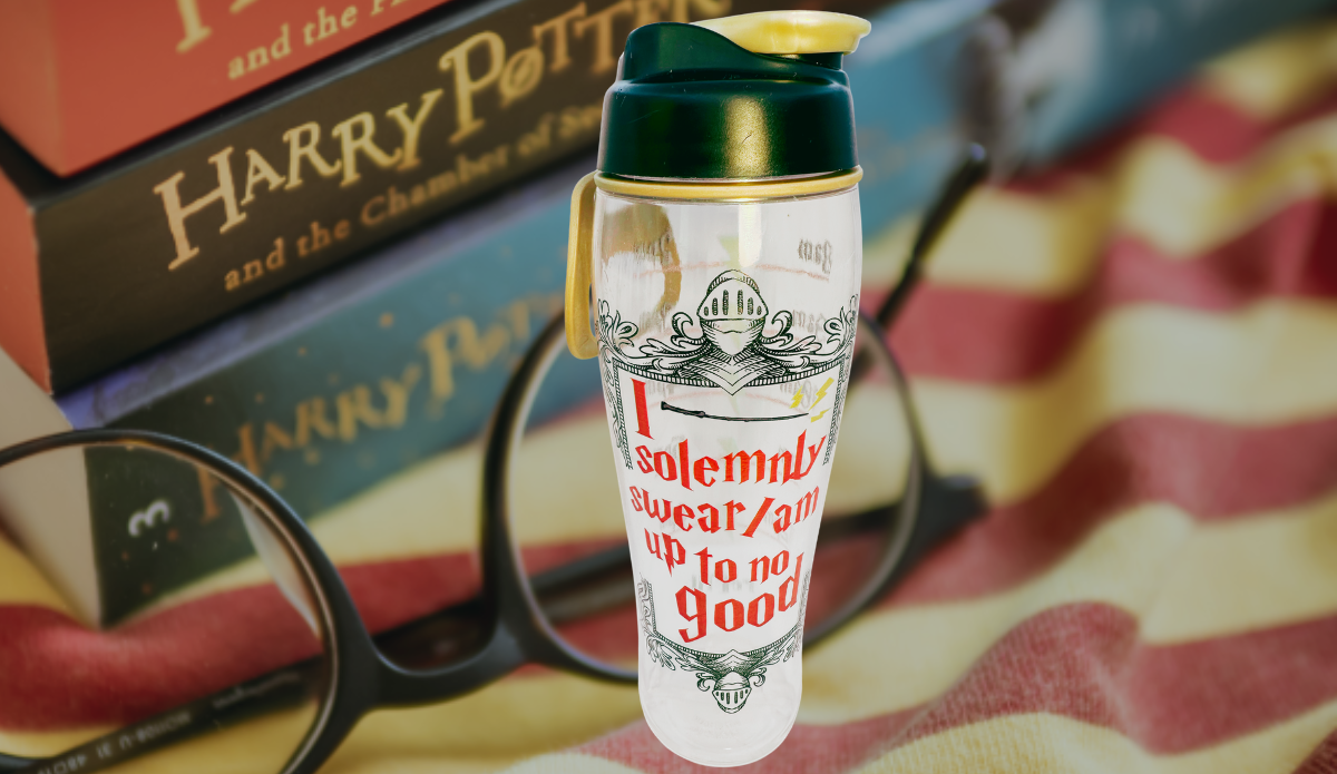 Harry Potter Up To No Good Water Bottle lifestyle scene with acrylic bottle, Wizarding World books, and round glasses