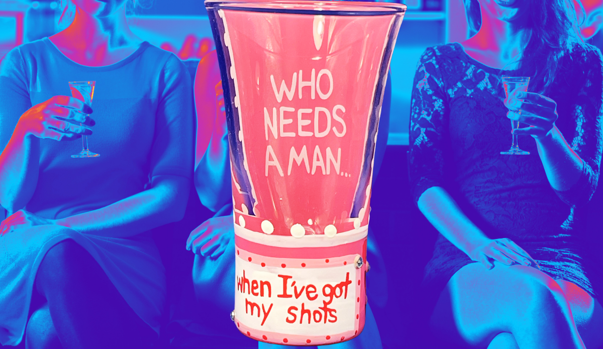 Lolita Who Needs a Man Shooter Glass displayed against blue and pink party scene with two women holding stemmed glasses
