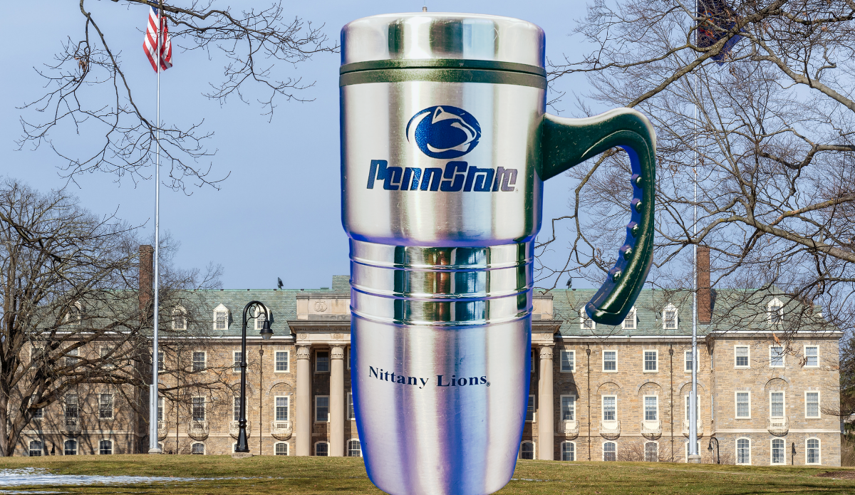 Penn State Travel Mug displayed on Penn State campus with university building and flag in the background