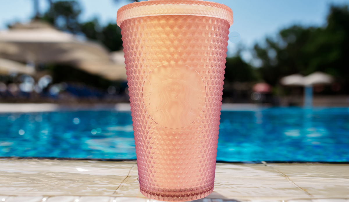 Starbucks Iridescent Rainbow Studded Venti Tumbler displayed beside a swimming pool