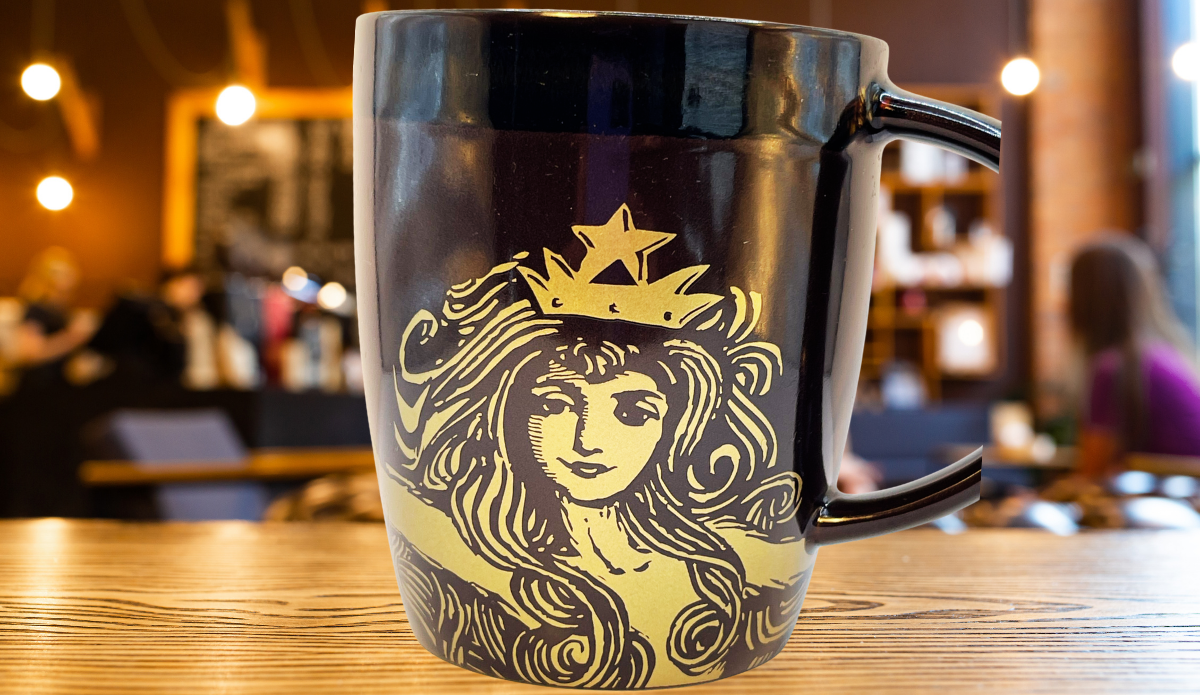 2012 Starbucks Anniversary Siren Mug displayed on cafe table with crowned Siren artwork
