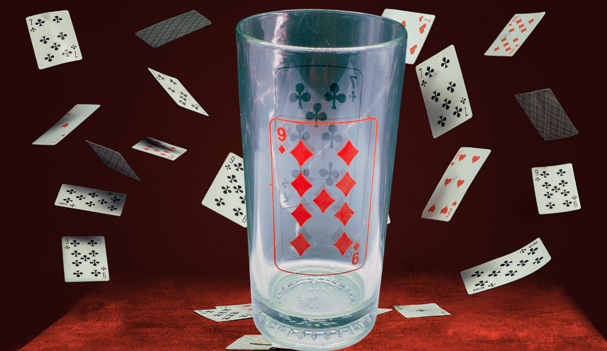 Diamonds and Clubs Drinking Glass displayed against deep red background with floating playing cards for a retro poker-night scene
