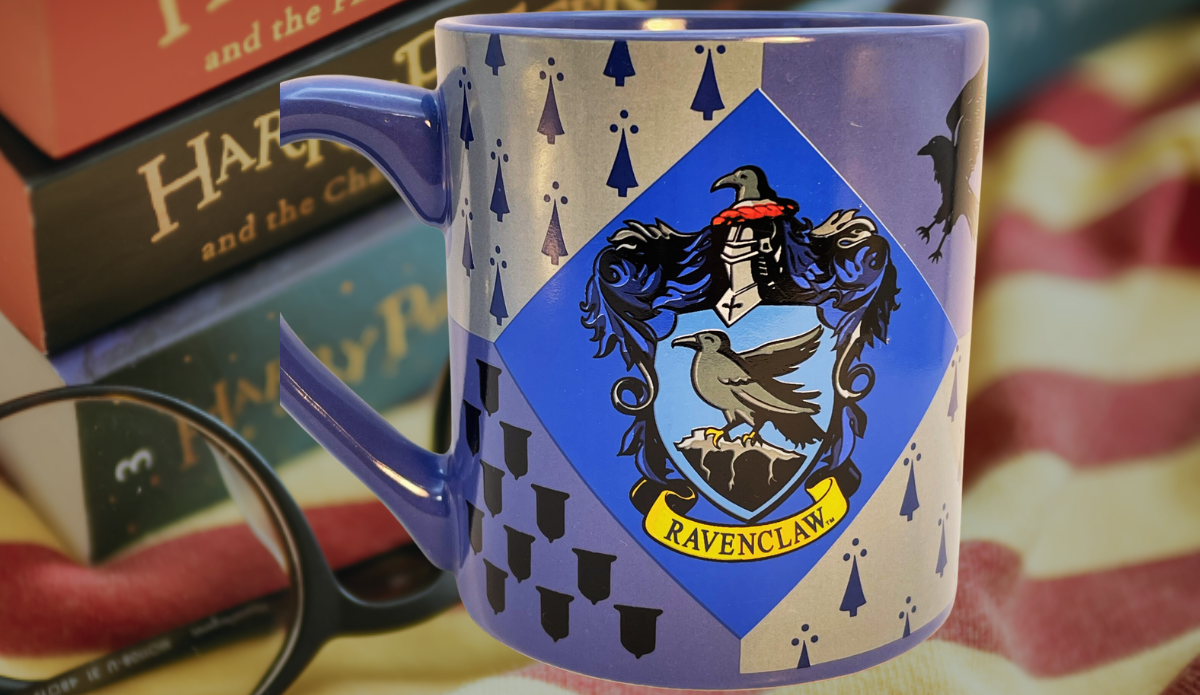 Harry Potter Ravenclaw House Crest Mug displayed with Harry Potter books and reading glasses in a cozy Wizarding World setting