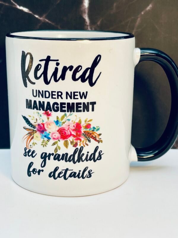 This charming 10-ounce white ceramic mug features a sleek shiny black handle and rim for a sophisticated look that stands out in any kitchen or office.