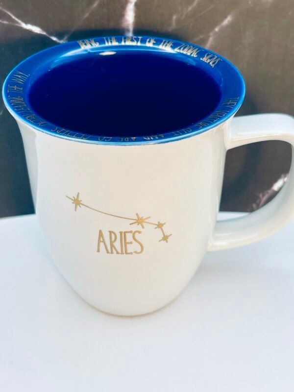 Astrology coffee mug featuring Aries lettering and rim text