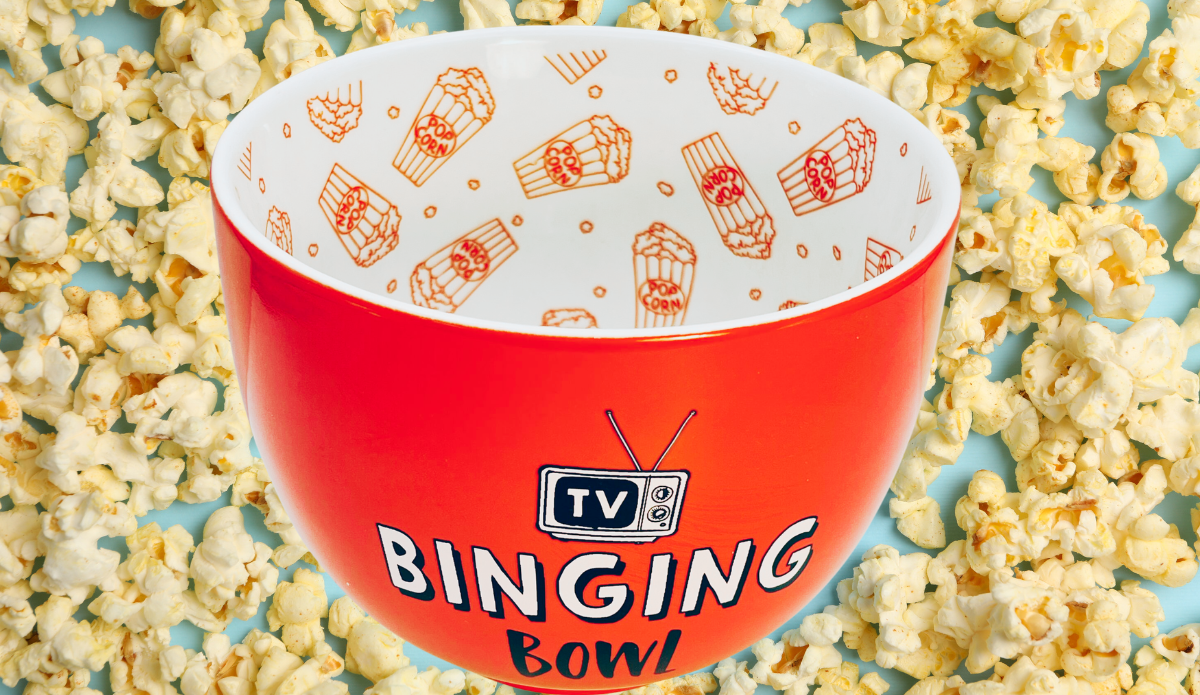 TV Binging Bowl displayed among freshly popped popcorn with red-orange exterior and patterned white interior