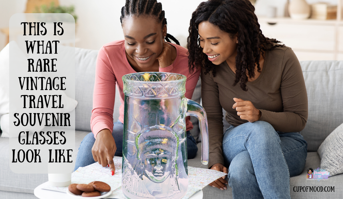 Two women studying a road map behind a large Statue of Liberty souvenir pitcher in a travel-themed lifestyle scene.