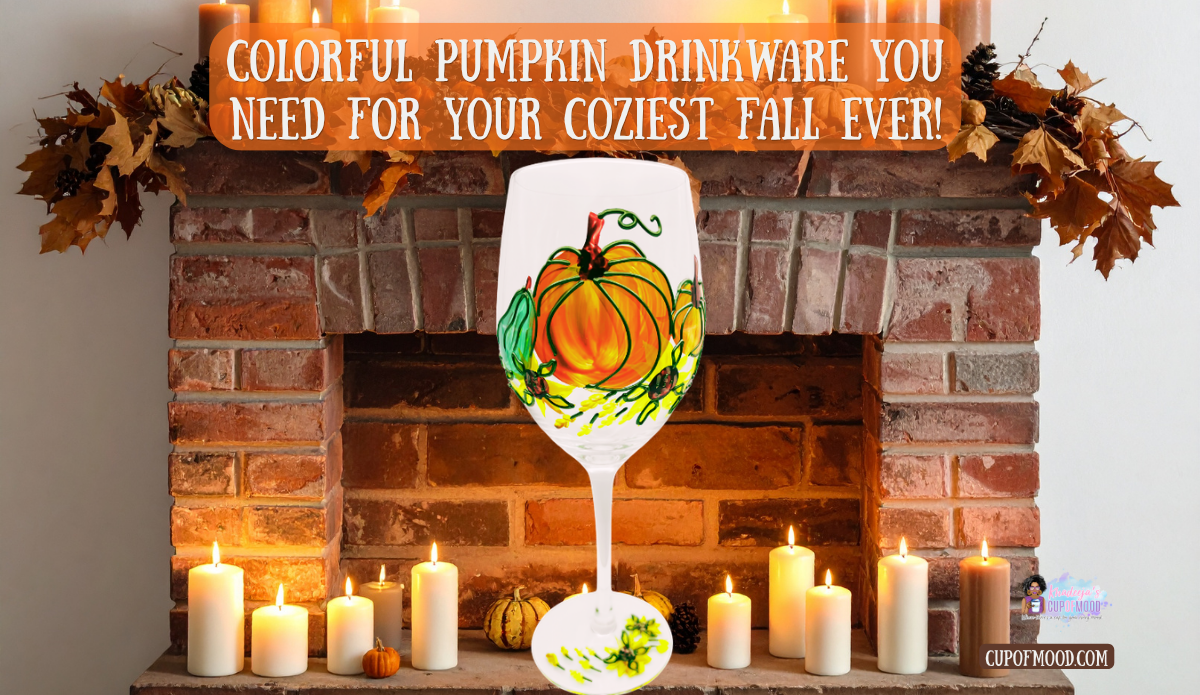 Hand painted pumpkin wine glass displayed in front of a brick fireplace surrounded by glowing candles and fall leaves