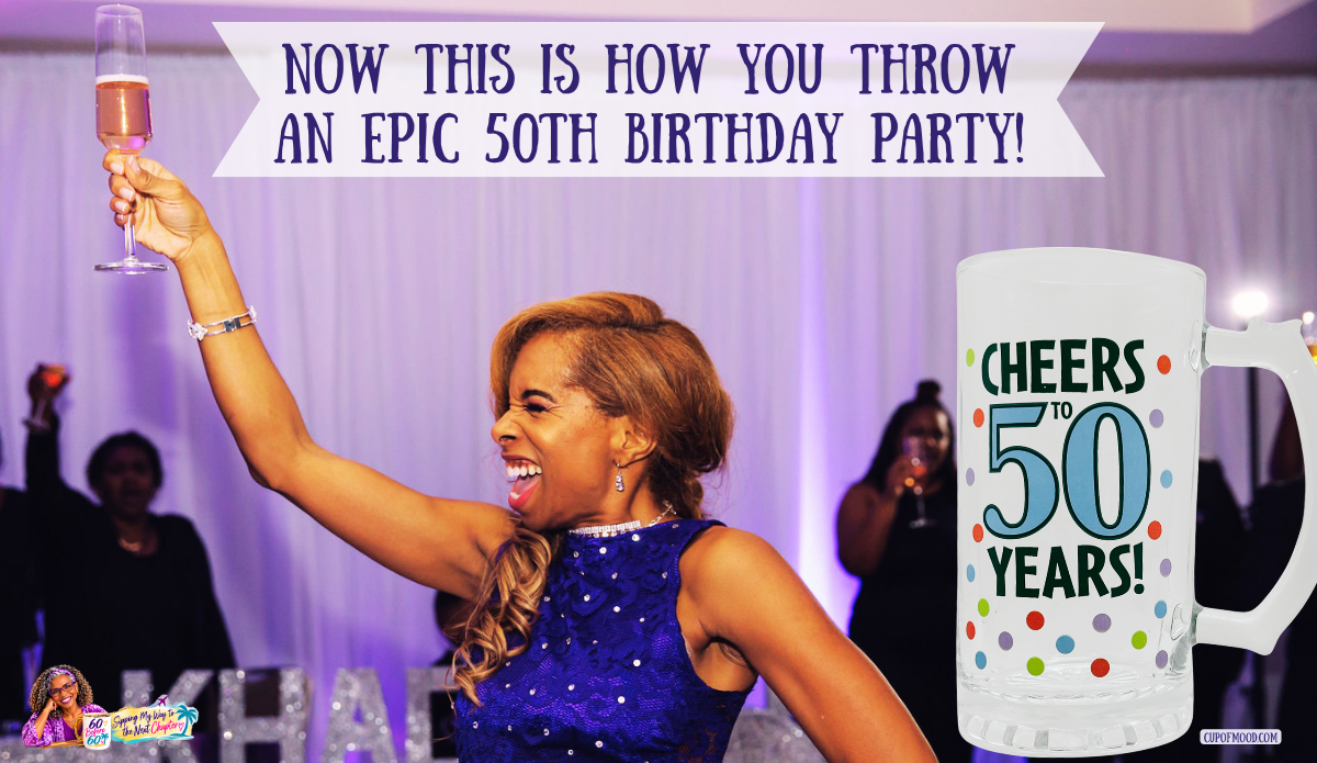 Khadeeja raising a champagne glass high during her 50th birthday toast, alongside a clear Cheers to 50 Years glass mug decorated with colorful dots.