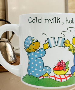 Berenstain Bears mug on kitchen counter near kettle and stove