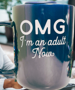 OMG I’m an Adult Now Funny Travel Mug in an office scene with a smiling Black woman at a computer