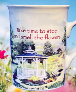 Chicken Soup for the Soul Floral Gazebo Mug styled in a bright floral setting with soft natural light