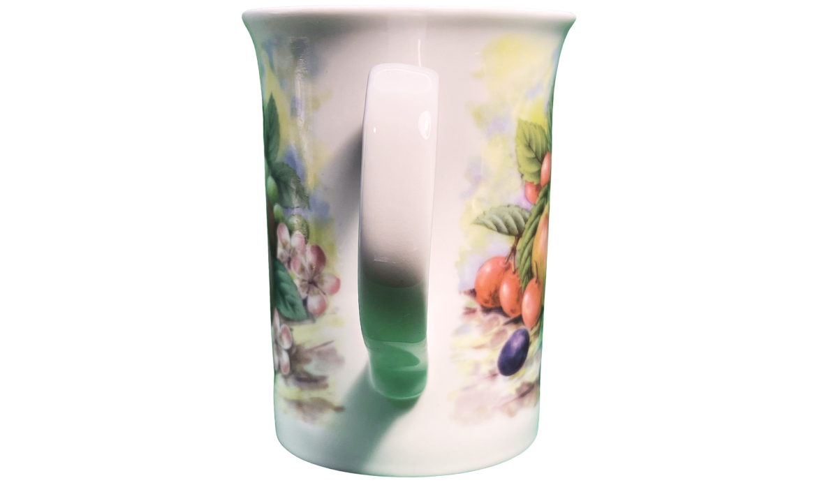 Handle view of the Churchill fruit mug with a slender white handle and wraparound orchard artwork