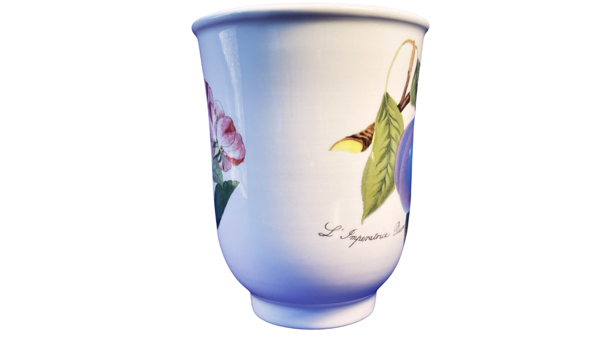 Middle view of the Portmeirion Pomona plum mug with botanical artwork and white ceramic surface