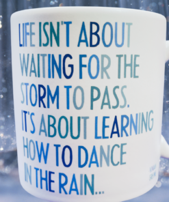 Dance In The Rain Mug displayed against a rainy blue background with sparkling water droplets.