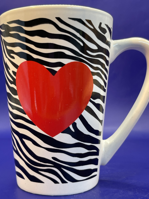 Indulge in a sip of wild romance with the Zebra Print Heart Latte Mug from the Fashionista Collection. Adorned with striking zebra stripes that evoke a sense of untamed elegance.