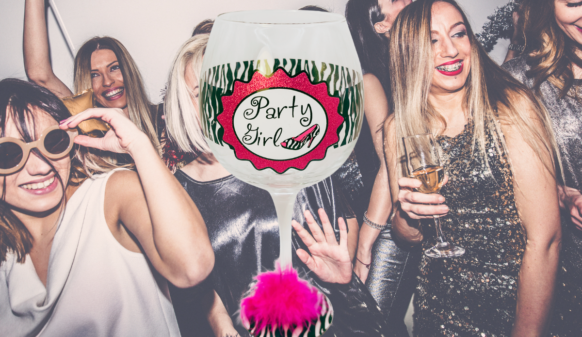 Party Girl zebra print wine glass in party setting with friends celebrating