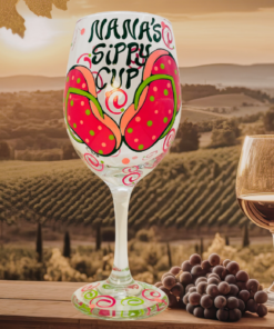 nana sippy cup wine glass displayed in vineyard setting with wine bottle and grapes