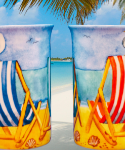 Kent Pottery Beach Chairs Mug pair displayed on tropical beach with palm trees and turquoise water