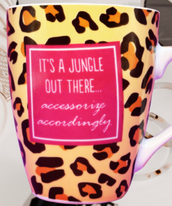 Jungle Out There Mug displayed with sunglasses, scarf, bracelet, and fashion accessories