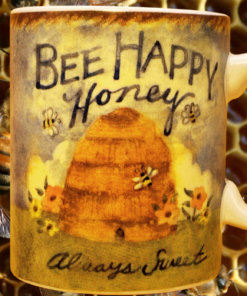 Cracker Barrel Bee Happy Honey Mug displayed against honeycomb with surrounding honey bees