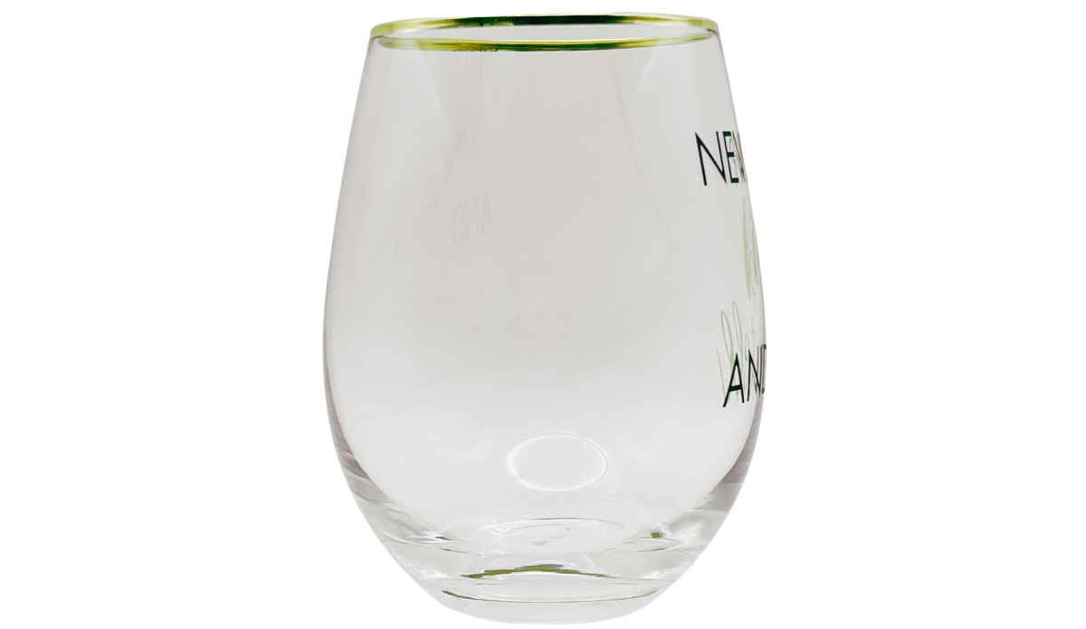 Mikasa Kiss And Tell Glass side view showing clear rounded body, gold-tone rim, and edge of front lettering