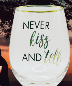 Mikasa Kiss And Tell Glass lifestyle scene with romantic sunset, silhouetted couples, and Never Kiss And Tell message
