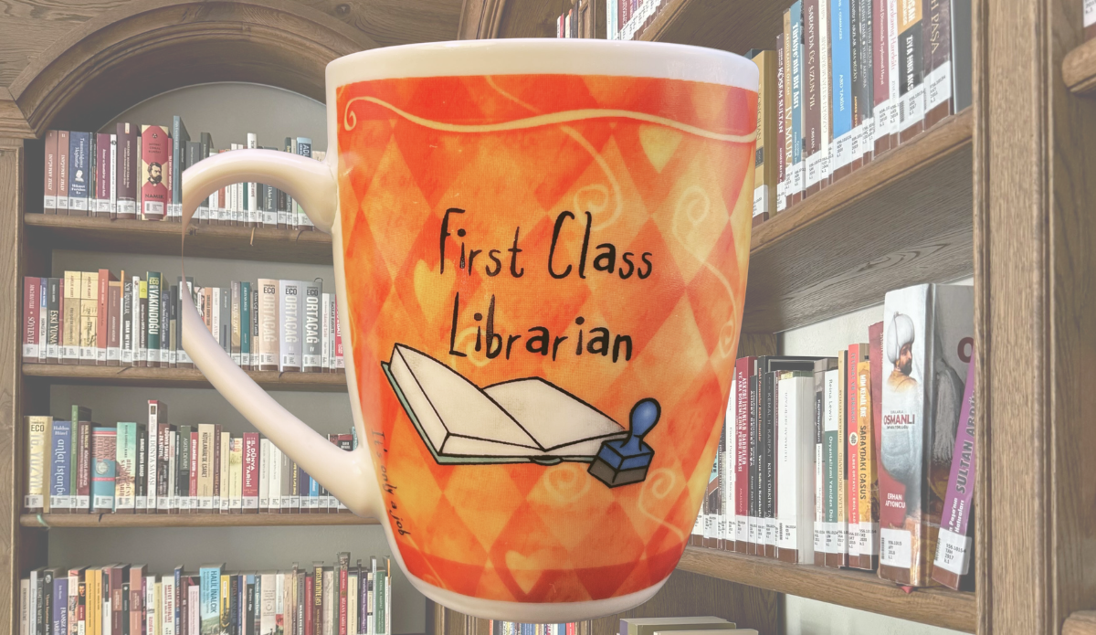 First Class Librarian Funny Mug styled on desk with books