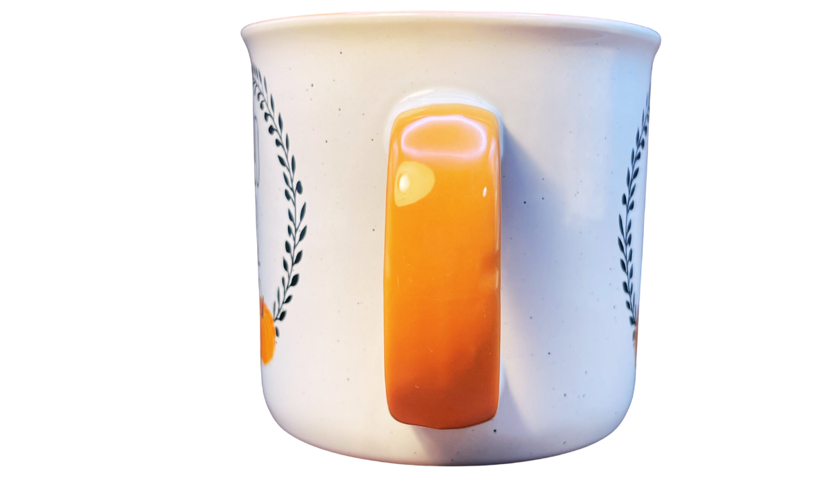 Cynthia Rowley Pumpkin Mug handle view showing the bright orange handle between the two decorated sides