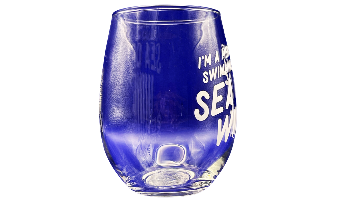 Right side view of clear Mermaid Sea Of Wine Stemless Wine Glass with partial white lettering