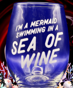 Mermaid Sea Of Wine Stemless Wine Glass surrounded by colorful mermaids, coral, fish, and underwater scenery