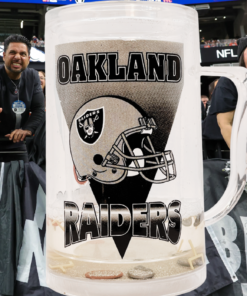 Oakland Raiders floating football acrylic freezer mug displayed with Raiders fans at football game