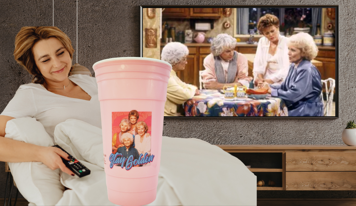 golden girls pink tumbler styled with cozy tv watching setup and blanket
