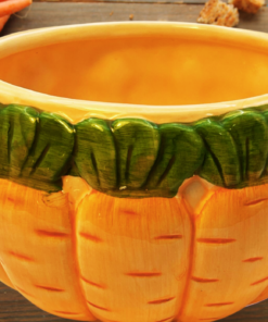 Vintage 3D Carrot Soup Mug displayed with fresh carrots on a rustic wooden table, featuring raised vegetables and a green leafy rim.