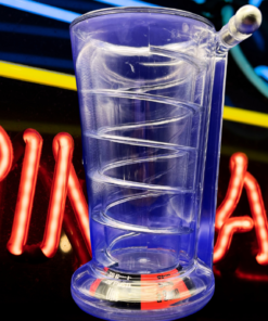 Pinball Pint Glass Drinking Game displayed in front of a colorful neon pinball sign