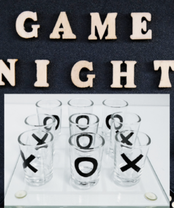 Tic Tac Toe Shot Glass Game displayed beneath wooden GAME NIGHT letters with colorful dice and party-game accessories.