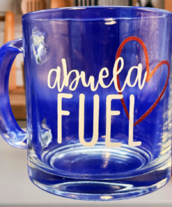 Abuela Fuel clear glass mug styled in kitchen with pink flowers wooden utensils and dish rack background