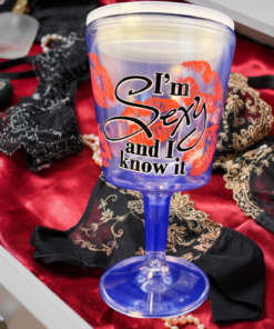Sexy Acrylic Wine Tumbler displayed with red satin, black lace, pearls, clear stem and base, and decorative accessories