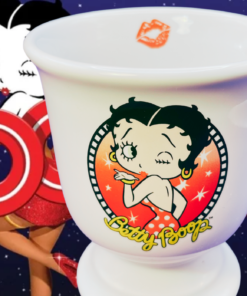 2006 Betty Boop Footed Pedestal Mug displayed against colorful Betty Boop cartoon artwork with bold red lettering