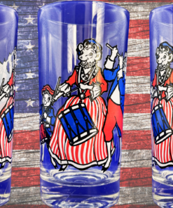 Vintage 1976 Elsie the Cow Bicentennial Glass displayed with rustic American flag background