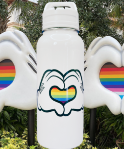 Disney Pride Mickey rainbow heart water bottle between Mickey glove heart sculptures with rainbow stripes