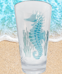 3D Acrylic Seahorse Tumbler displayed on sandy beach with turquoise ocean waves