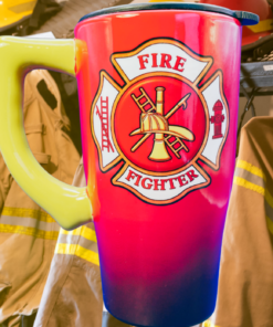 Firefighter Maltese Cross Travel Mug in firehouse scene with firefighter gear, red and navy body, yellow handle, and emblem
