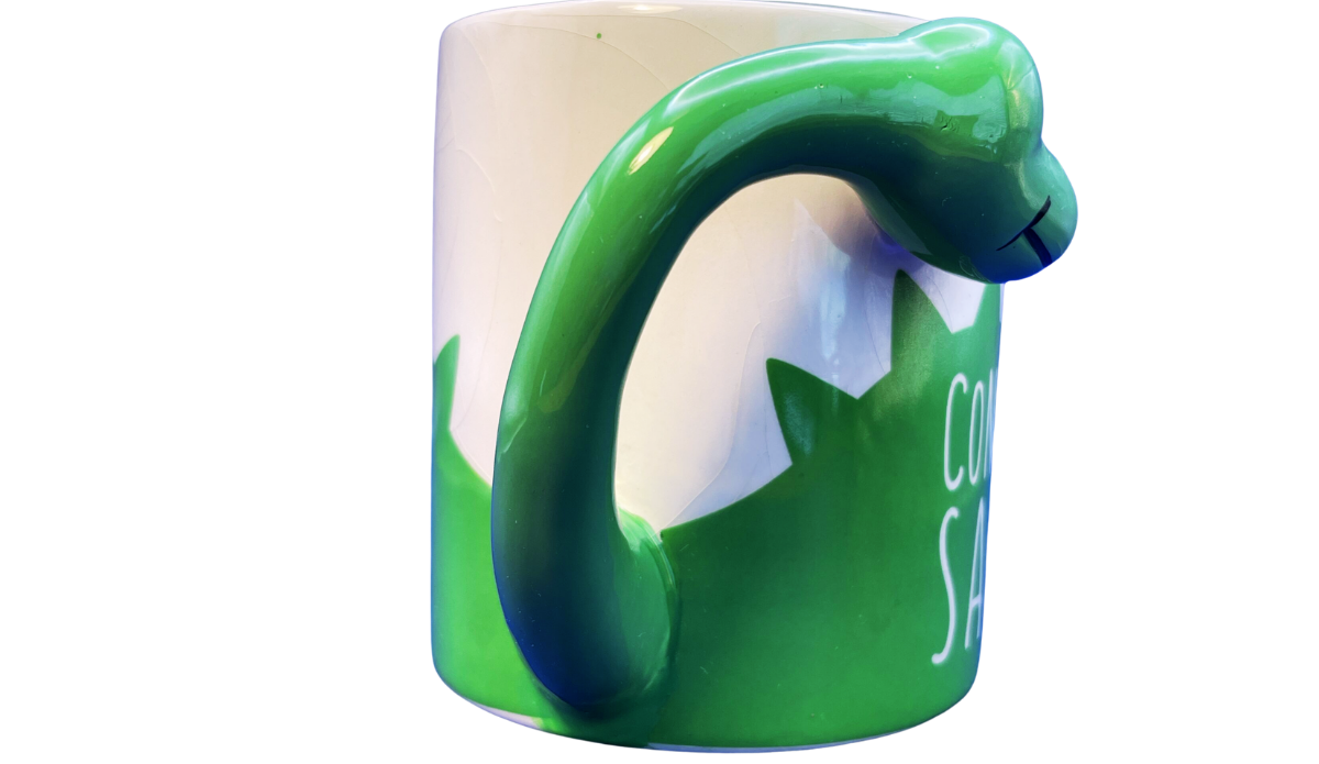 Side view of BigMouth Coffee Connoisaur Dinosaur Mug showing the sculpted dinosaur head and neck handle