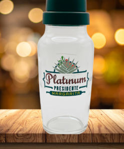 Chili’s Platinum Presidente margarita glass shaker with black lid on wooden bar with warm lighting background