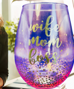 wife mom boss wine glass on desk with woman smiling in background showing gradient glass and confetti detail