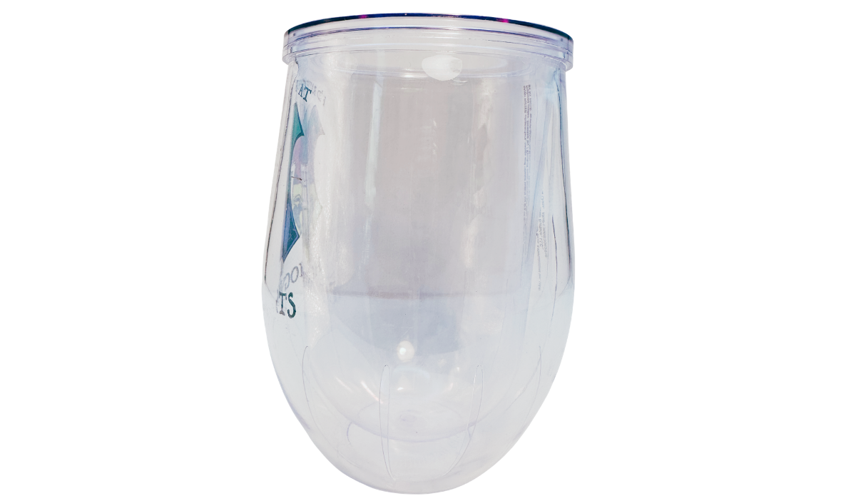 Harry Potter Hogwarts Stemless Travel Tumbler left side view showing the clear double-wall acrylic body with the edge of the Hogwarts crest visible through the transparent tumbler.